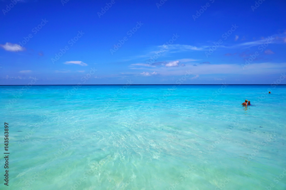 Seychelles Islands - March 14, 2016: Scenic seascape of azure transparent ocean water and blue sky. Tropical beach with white sand. Idyllic scenery of seaside resort
