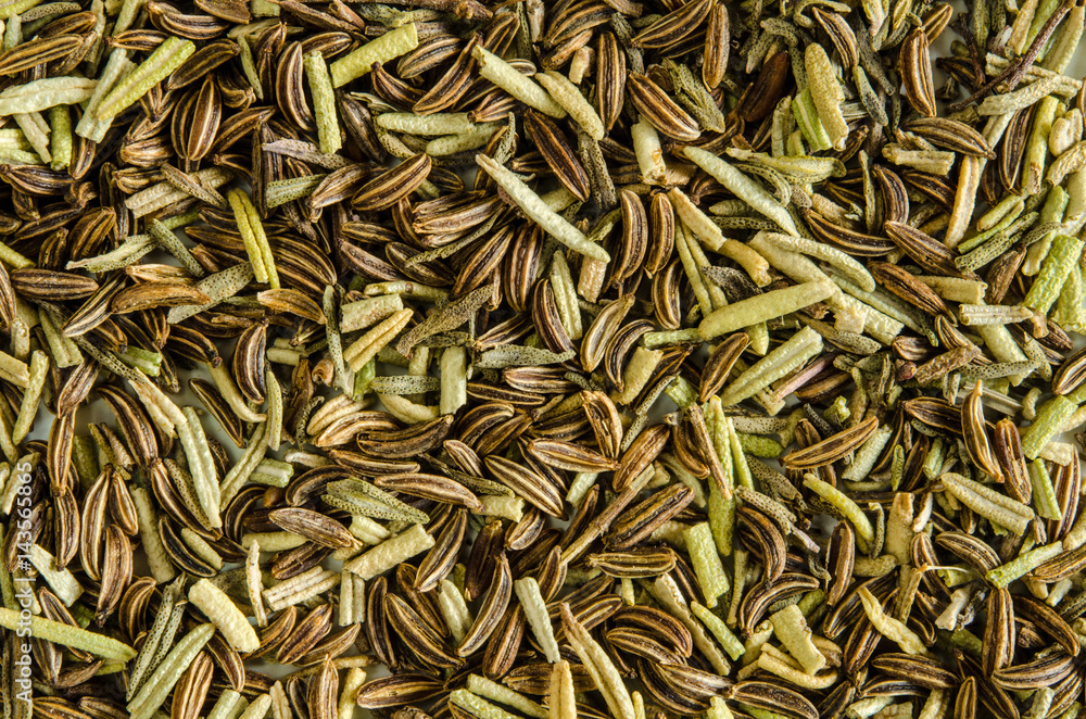 Dry leaves of rosemary and seeds of caraway. Food background. Closeup macro shot. Top view. Dry leaves of rosemary and seeds of caraway. Food background. Closeup macro shot. Top view.