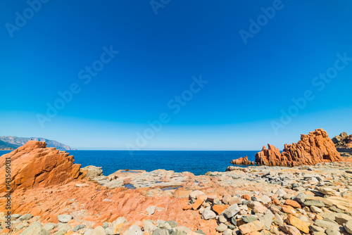 Red rocks beach under a blue sky