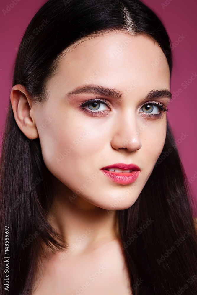 beautiful young brunette woman on a pink background in the studio beautiful young brunette woman on a pink background in the studio