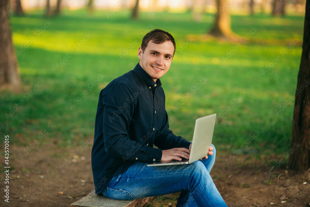 The young manager working on a laptop in the park. Lunch Break. The young manager working on a laptop in the park. Lunch Break.
