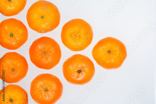 High angle view of a pyramid of whole ripe mandarins on white background