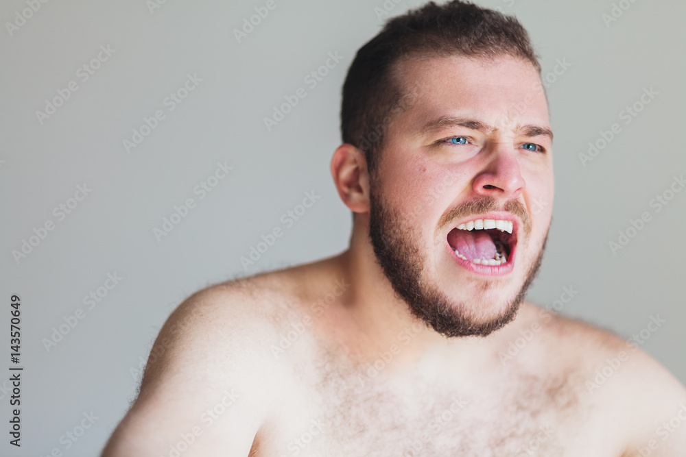 Young emotional man screaming in anger Young emotional man screaming in anger