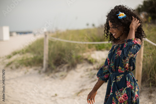 Fashion woman walking on beach with a summer dress