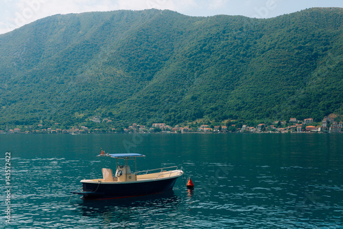 The old town of Perast on the shore of Kotor Bay, Montenegro. The ancient architecture of the Adriatic and the Balkans. Boats and yachts on the dock.