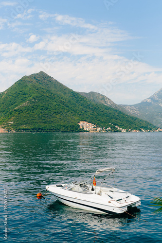 The old town of Perast on the shore of Kotor Bay, Montenegro. The ancient architecture of the Adriatic and the Balkans. Boats and yachts on the dock. © Nadtochiy