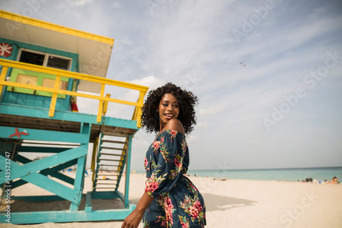 Fashion woman walking on beach with a summer dress