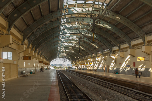 Wide view of a locomotive electric train station platform with covered tunnel, Chennai, India, Mar 29 2017