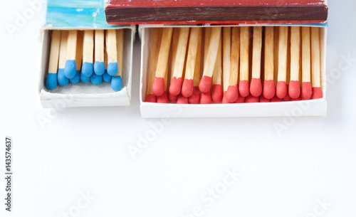 Wooden colorful matchsticks in the boxes. Red  blue matches against white background. Macro view