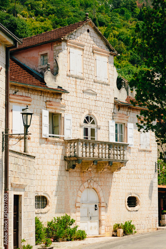 Balcony with columns in an old house. Balkan architecture. Montenegrin balconies