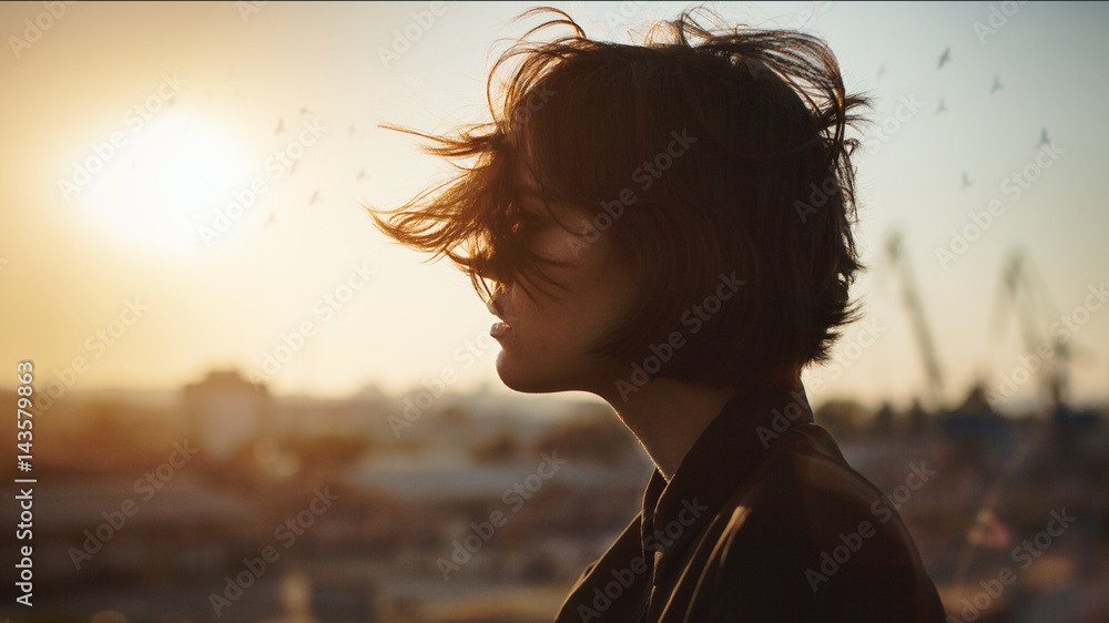 Obraz premium Melancholic beautiful portrait profile. Young girl, autumn mood, birds in the city sky. The port is abrasive against the background. Romantic affecting mood