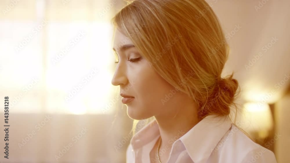 Young beautiful blonde woman turning head and looking at camera Young beautiful blonde woman turning head and looking at camera