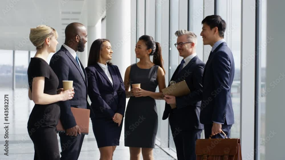 Portrait smiling mixed ethnicity business team in large modern office Portrait smiling mixed ethnicity business team in large modern office