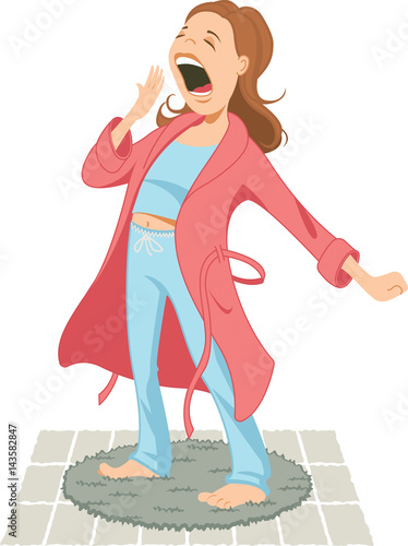 Woman wearing pajamas and bathrobe stretching and yawning