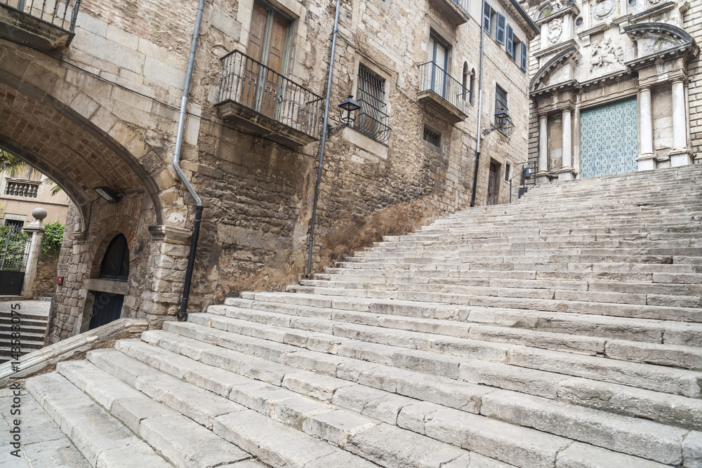 Street view, ancient buildings, stone stairs,historic center, Pujada de Sant Domenec or Escalinata de Sant Marti, Girona, Catalonia,Spain.