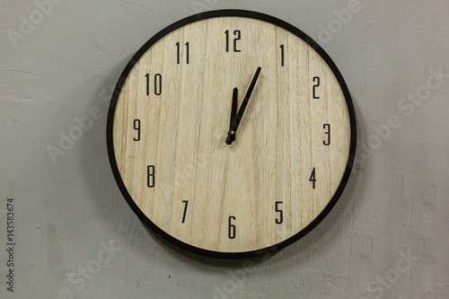 Black and white clock hanging on a leather belts, decorative wall gray background