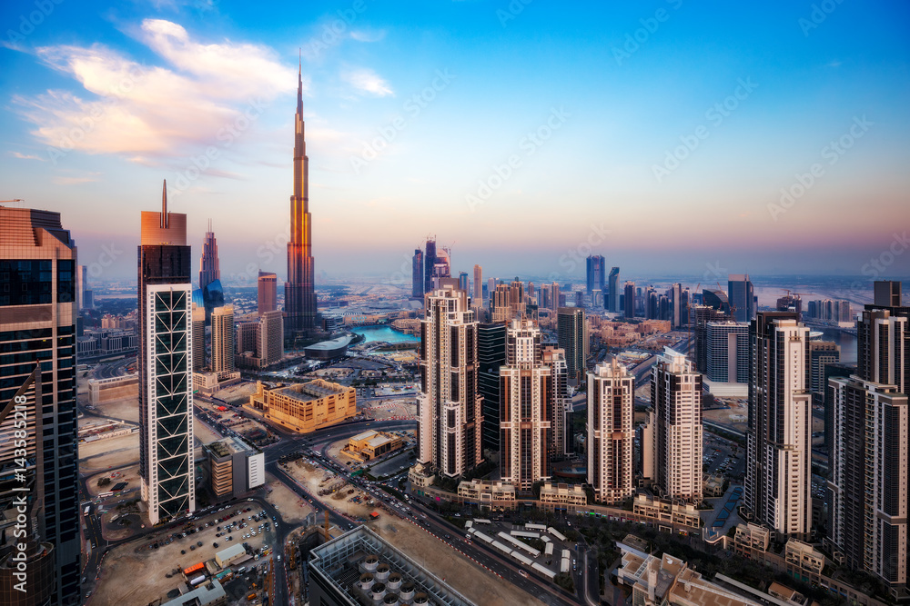 Spectacular aerial view of Dubai, UAE, at sunset. Colourful skyline of a big modern city. Travel background.