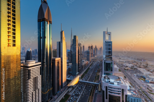 Aerial view over a big modern city. Skyscrapers of downtown Dubai, United Arab Emirates. Scenic daytime panoramic skyline. Travel and architecture background.