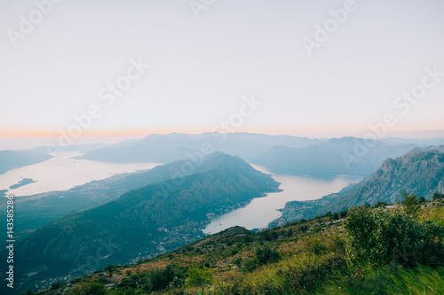 Bay of Kotor from the heights. View from Mount Lovcen to the bay. View down from the observation platform on the mountain Lovcen. Mountains and bay in Montenegro. The liner near the old town of Kotor.