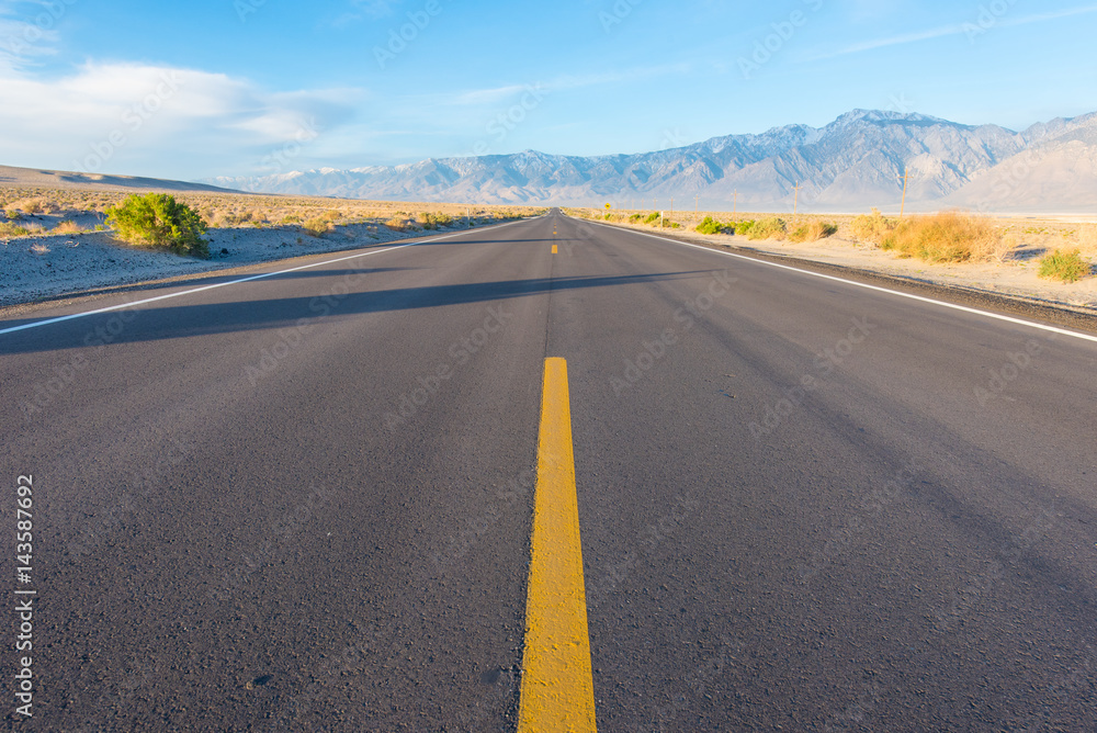 Yellow line in middle of road in desert Yellow line in middle of road in desert