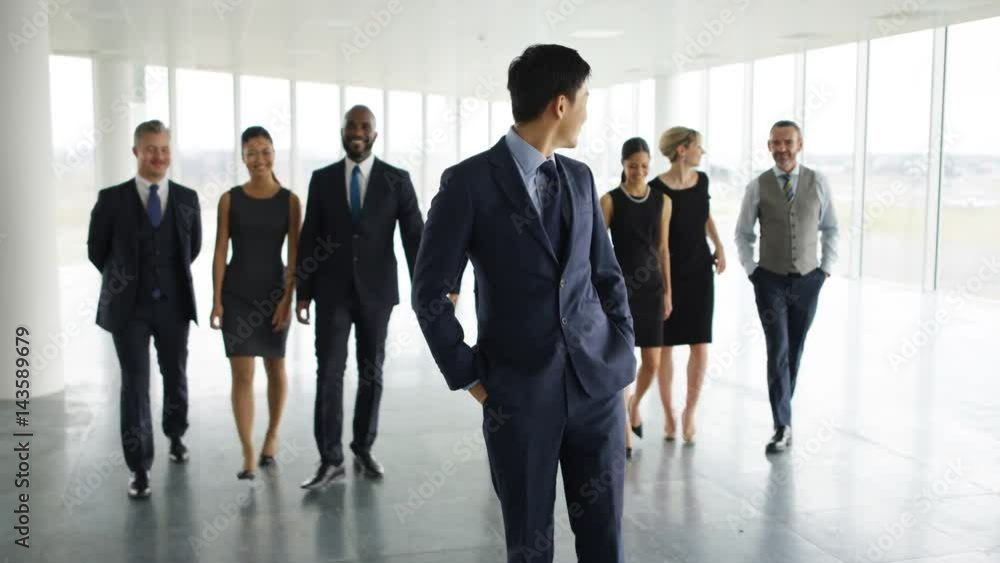 Portrait happy multiracial business team in large open plan office Portrait happy multiracial business team in large open plan office