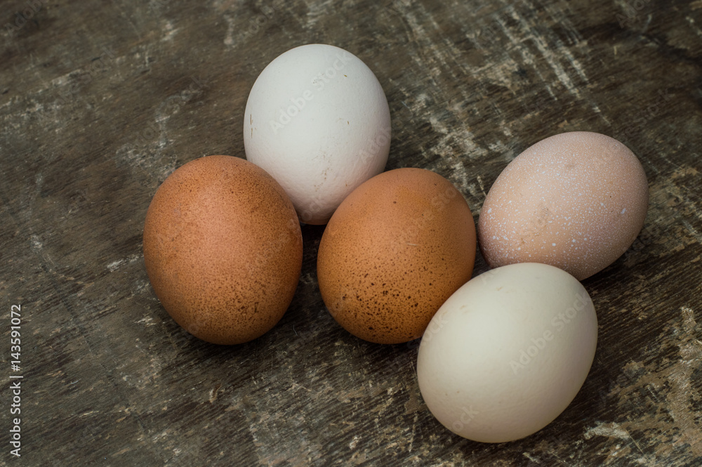 Five fresh chicken eggs on an old wooden background Five fresh chicken eggs on an old wooden background