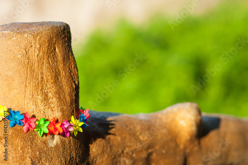 Wooden hence with colorful flowers decoration and copy space on the blurred bokeh background. Outdoors, sunny weather. Happy style, close up