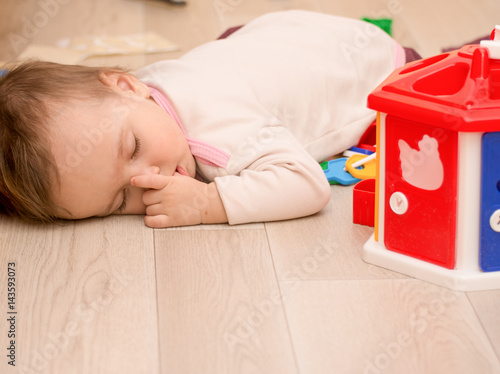 The child fell asleep on the floor