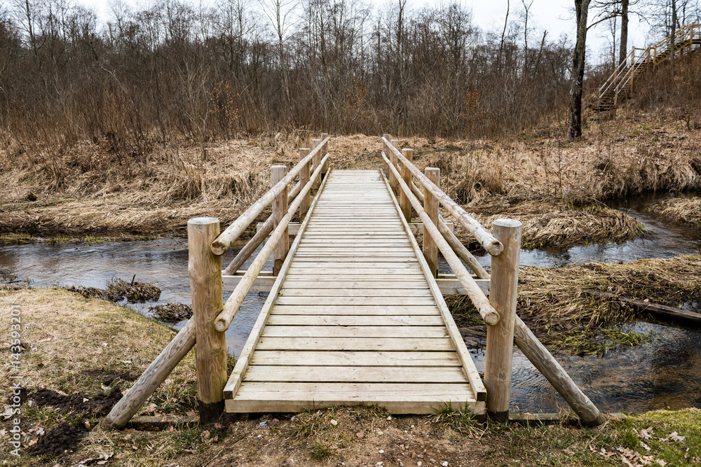 wooden boardwalk with bird watch tower in early morning wooden boardwalk with bird watch tower in early morning