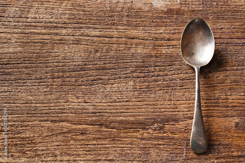 Rusty spoon on wooden table