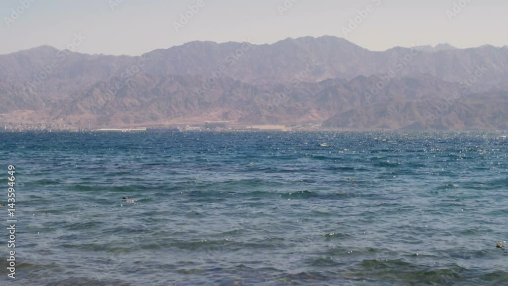 Red sea water with Jordan's mountains in the horizon Red sea water with Jordan's mountains in the horizon