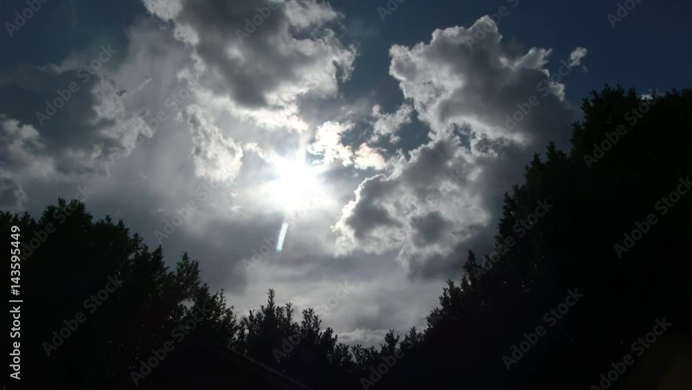Sun shining as storm clouds pass over tree line in Portland, Oregon, real time. Sun shining as storm clouds pass over tree line in Portland, Oregon, real time.
