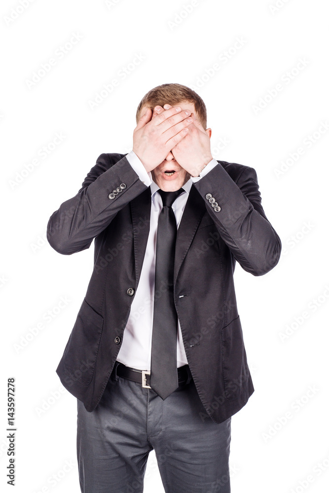 portrait young businessman covering his eyes with his hand. emotions, facial expressions, feelings, body language, signs. image on a white studio background. portrait young businessman covering his eyes with his hand. emotions, facial expressions, feelings, body language, signs. image on a white studio background.