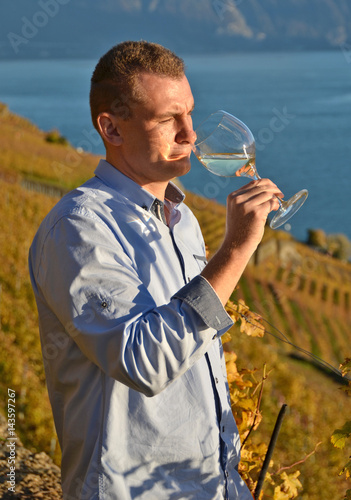 Man holding a glass of wine. Lavaux, Switzerland © HappyAlex