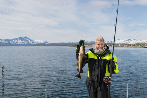 Beautiful girl fishing in northern Norway