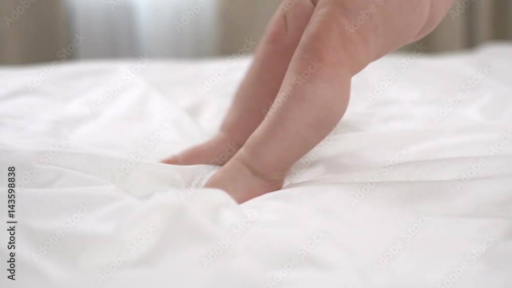 Little girl learns how to walk on the bed slow motion Little girl learns how to walk on the bed slow motion