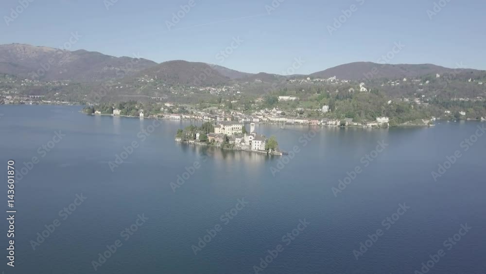 4K Aerial shot of San Giulio Island and the village of Orta San Giulio. The island is situated in Orta Lake in Piedmont, northwestern Italy, Europe. LOG footage version 4K Aerial shot of San Giulio Island and the village of Orta San Giulio. The island is situated in Orta Lake in Piedmont, northwestern Italy, Europe. LOG footage version