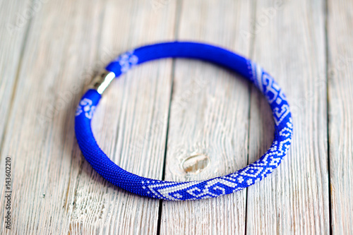 beautiful blue bracelet lies on a wooden table, women's ornament