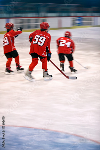 boys play ice hockey.