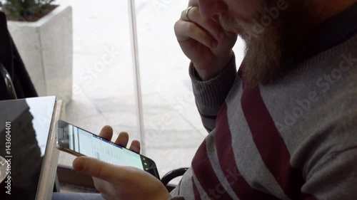 Young man using smartphone in cafe bar