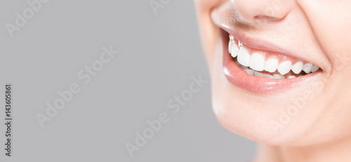 Beautiful smile young woman. White teeth on the master plan.