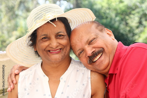 Relaxed close-up portrait of happily married, elderly Asian couple