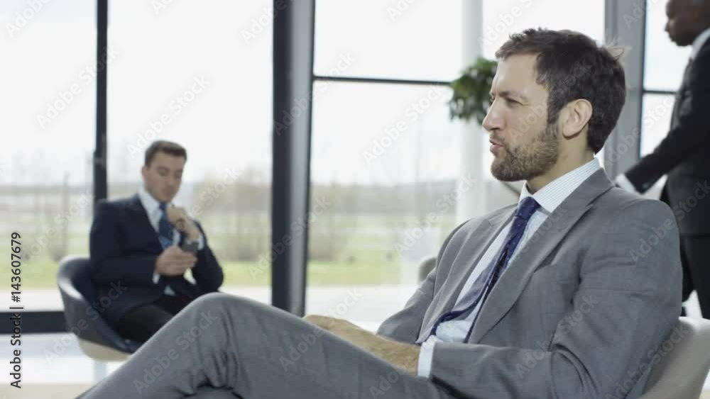 Diverse corporate business group chatting in meeting area of modern office Diverse corporate business group chatting in meeting area of modern office