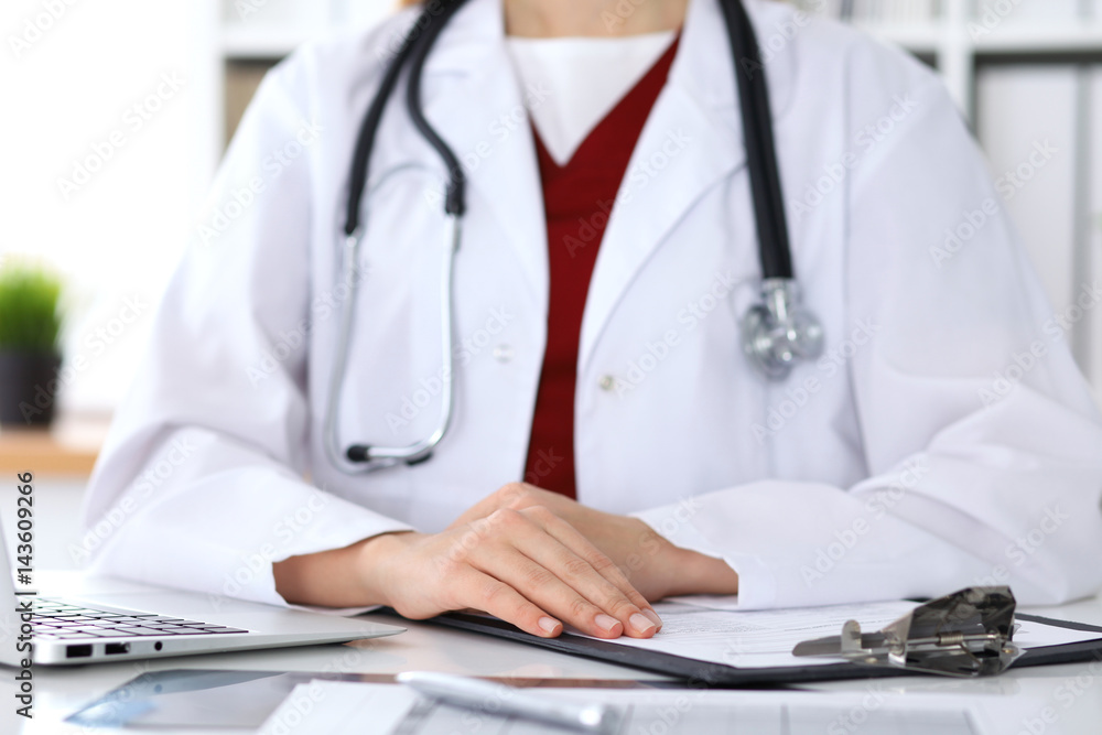 Close up of a unknown female doctor's hands. Physician is ready to consult and halp patients. Medicine and health care concept Close up of a unknown female doctor's hands. Physician is ready to consult and halp patients. Medicine and health care concept