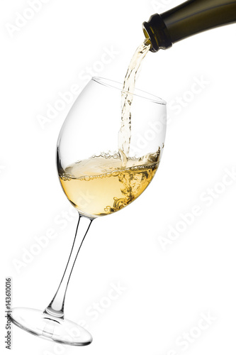 white wine poured from a bottle into wine glass on white background, isolated