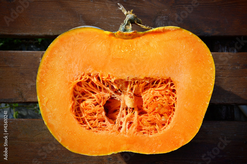 Fresh pumpkin cutting in half, isolated on a white.