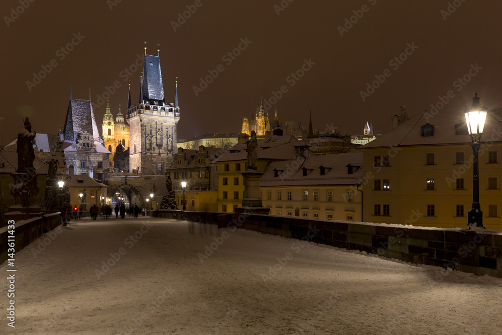 Night snowy Prague Lesser Town with Bridge Tower and St. Nicholas' Cathedral from Charles Bridge, Czech republic