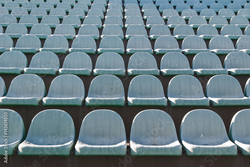 Rows of old theater chairs in the open air. Background
