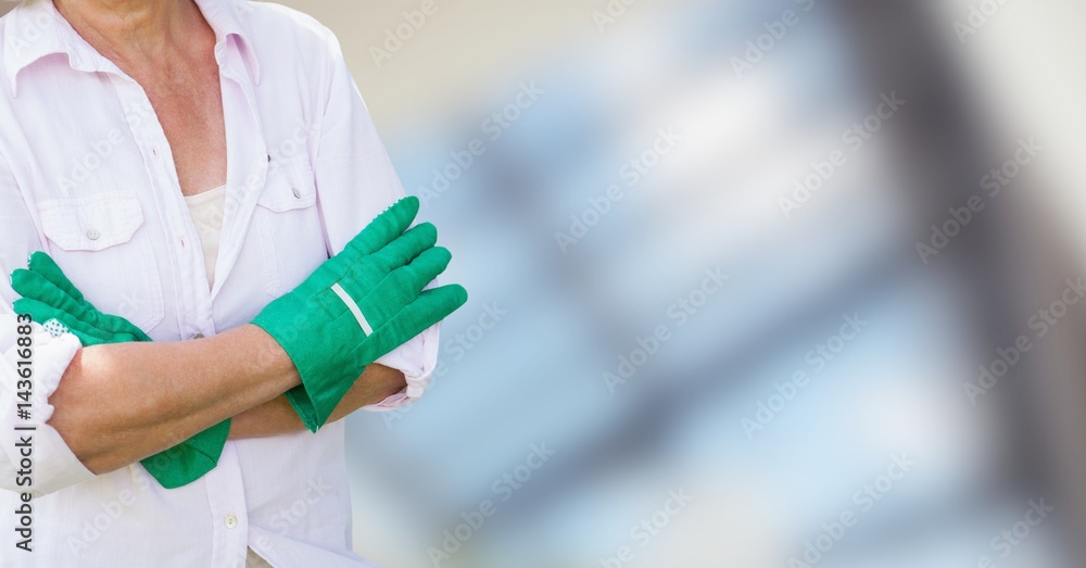 Gardener with her hands folded on blurred background Gardener with her hands folded on blurred background
