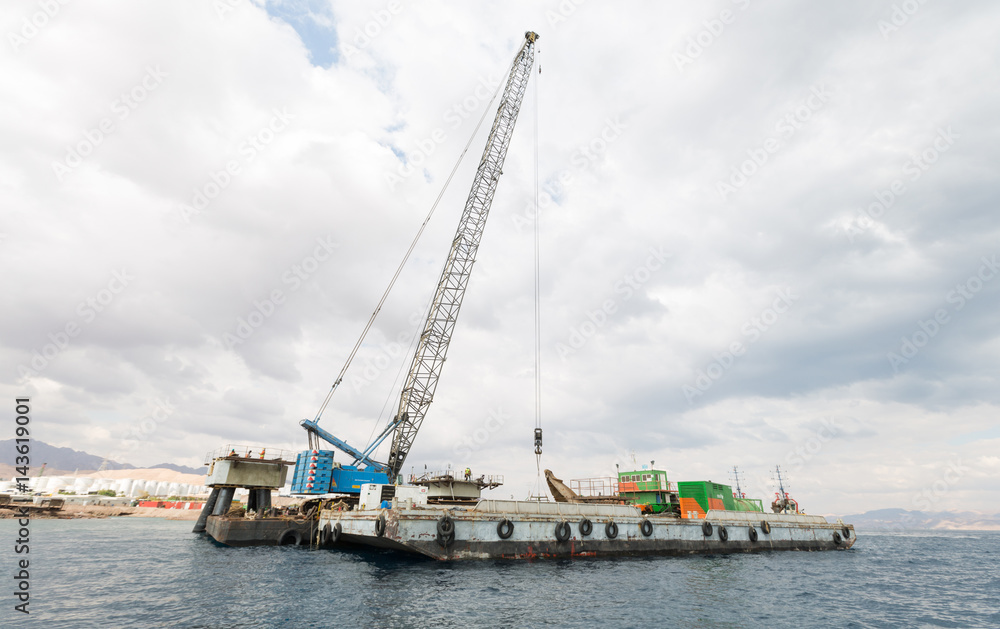 Aqaba, Jordan, 10/10/2015, Construction crane working on a jetty terminal at aqaba new port.